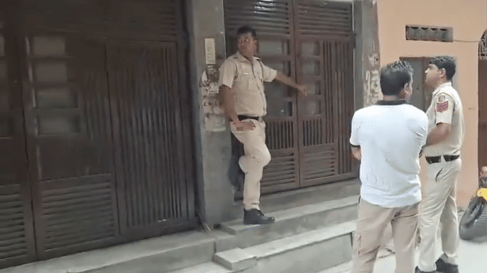 Delhi police outside the house of cop Manish Bhati, who is at large after shooting his wife | Screengrab/ANI